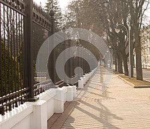 Road and fence flooded with sun