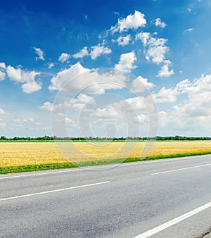 Road, field and sky with clouds