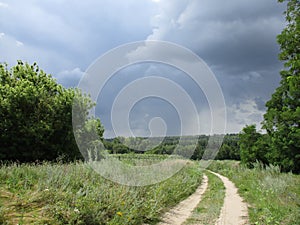 Road in a field during a thunderstorm