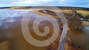 Road through filed tide time, aerial flight view Lithuania