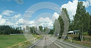 Road in Finland. blue sky and white clouds