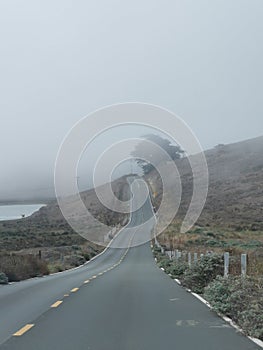 On the road in foggy morning to Point Reyes Lighthouse, California, USA