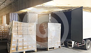 Road freight cargo shipment by truck. Large shipments pallet goods waiting for load into container shipping truck