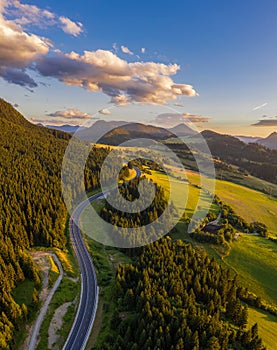 Road going through forests of the Liptov region in Slovakia at sunset