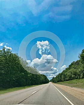 Road green trees clouds leading lunes photo