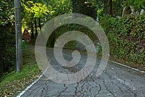 A road on a hill with a road sign at the edge of it photo