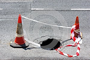 Road hole with warning cones