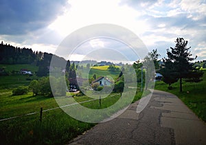 Road, houses and clouds in countryside in Germany