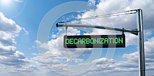 Road information board with text DECARBONIZATION