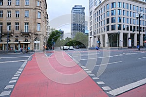 Road infrastructure, maintenances, pedestrian crossing across wide road painted red on asphalt, FRANKFURT - July 15, 2023