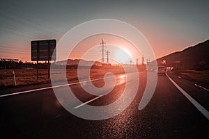 Road, infrastructure, transportation during sunset near a city, without smog, with amazing light and cars