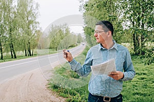 The road inspector on a working platform. Stacking of new asphalt photo