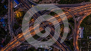 Road interchange in the city at night with vehicle car light movement, Aerial view