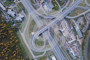 Road interchange on the outskirts of the city of Krasnoyarsk, captured on a drone camera, top view, forest outskirts and
