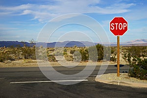 A road junction with a stop sign in Joshua Tree National Park, USA