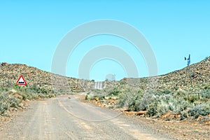 Road landscape, with uneven roadway sign, on historic Postal Route