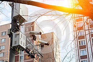 Road and lane tracking cameras hang over the roadway. Against the backdrop of urban high-rise buildings