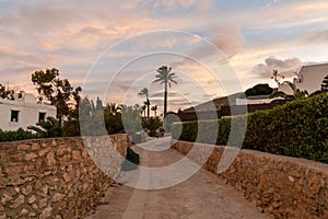 Road leading to idyllic vacation homes on the Costa del Sol in Agua Amarga in Andalusia at sunset