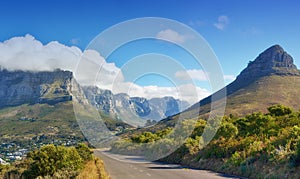 A road leading to Lions Head, Table mountain and the Twelve Apostles in Cape Town, South Africa. Peaks and lush green