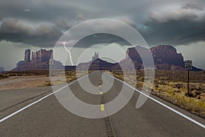 Road leading to Monument Valley, AZ with thunderbolt in the backgorund