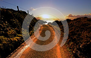 Road leading to sunset over Pembroke Coast