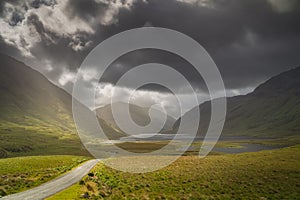 Road leading trough Doolough Valley with lakes andmountain range, Ireland