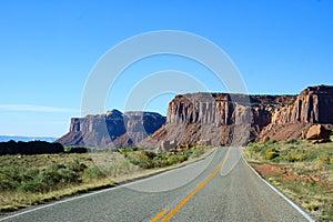 The Highway Leading In To Canyonlands, Utah. Blue Sky, Red Rocks, Green Grass, Remote Location