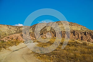 The road leads to the beautiful Pink valley, Gulludere and White mountain, Aktepe Hill. Cappadocia, Turkey