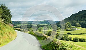 Road leads to distance in Welsh valley