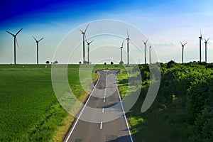 road leads to wind turbines producing alternative energy