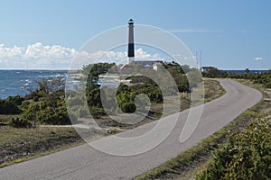 Road, lighthouse and the sea