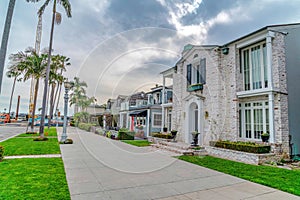 Road lined with palm trees and beautiful houses in scenic Long Beach California