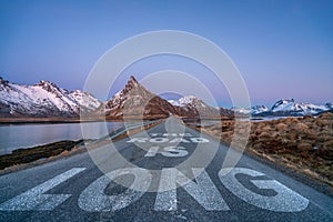 the road is long text quote printed on asphalt road