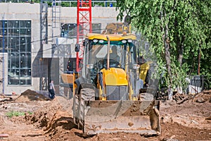 Road machine by construction site