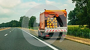 Road maintenance truck and signalization for road works photo