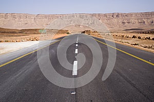 Road in Makhtesh crater Ramon, is a geological landform of a large erosion cirque in the Negev Desert, Southern Israel