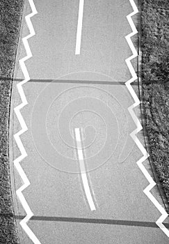 Road markings on bicycle lane through the park, from above