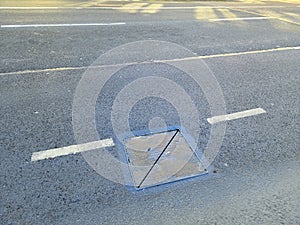 Road with markings and an iron hatch