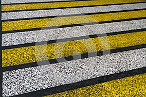 Road markings on wet asphalt. White yellow zebra for pedestrian safety. Pedestrian crossing. A copy place