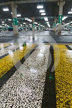 Road markings on wet asphalt. White yellow zebra for pedestrian safety. Pedestrian crossing. A copy place