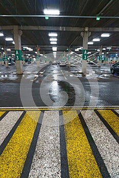 Road markings on wet asphalt. White yellow zebra for pedestrian safety. Pedestrian crossing. A copy place