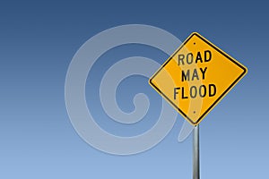 Road May Flood Sign Against A Clear Blue Sky