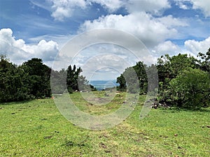 road in the middle of the mountain with blue sky and clouds