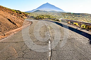 A road with a mountain in the background