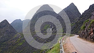 Road in the mountains, black rocks, steep hills