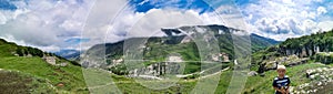 A road in the mountains of Dagestan with large mountains in the background and clouds. Russia.