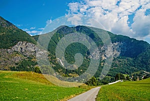 Road in mountains in Flam, Norway. Country road on mountain landscape. Beauty of nature. Hiking and camping. Summer trip