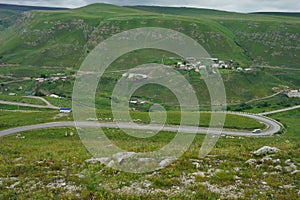 Road in mountains. Houses in beautiful place. Live in mountains. Travelling background.