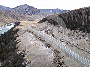 road in the mountains near a river. Chui highway is one of most beautiful roads in the world. Chuysky tract