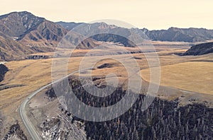 road in the mountains near a river. Chui highway is one of most beautiful roads in the world. Chuysky tract